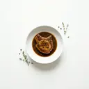 Schweinekotelett gedünstet, mit Grundsauce dunkel/braun